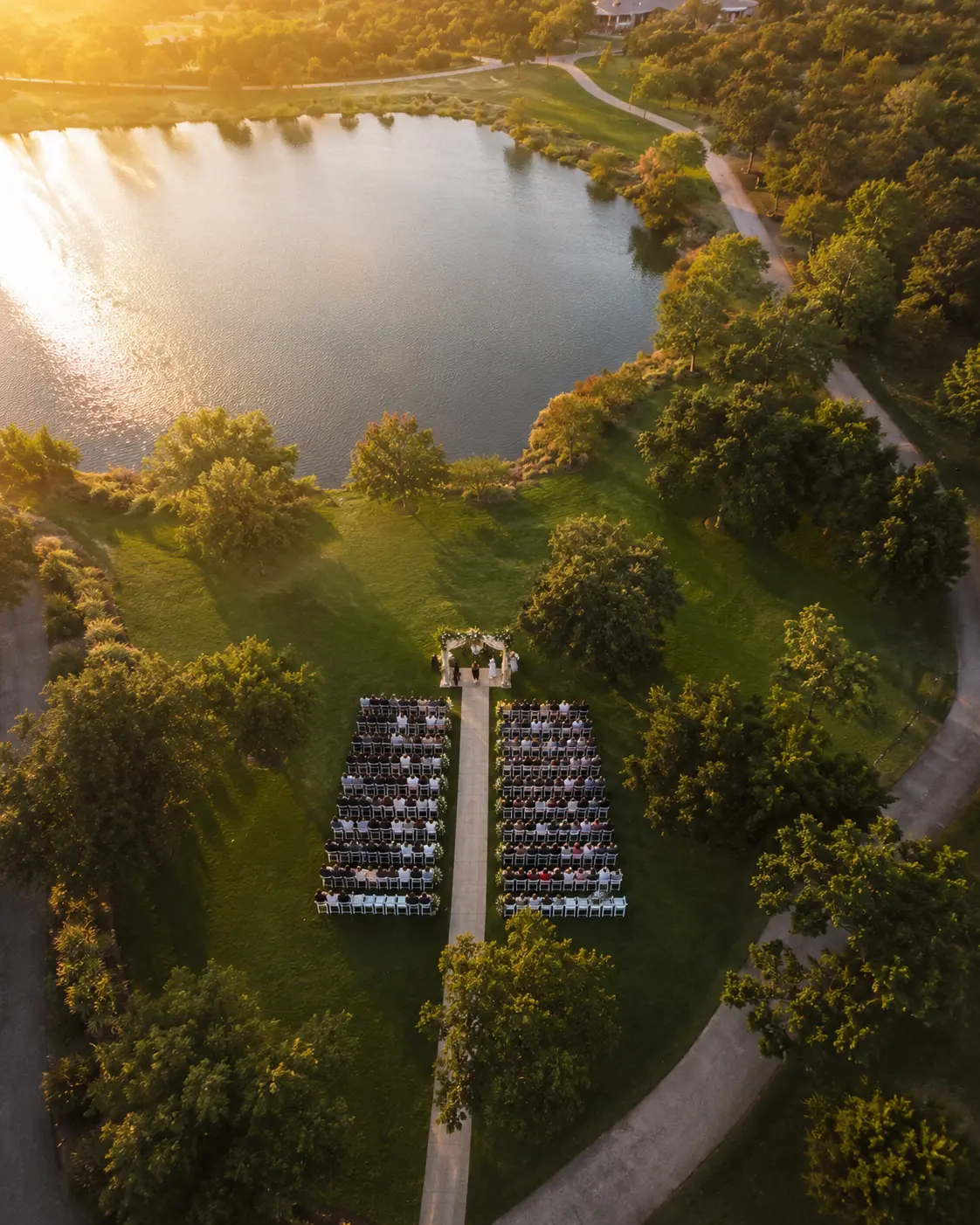 Aerial view of an outdoor wedding by a lake